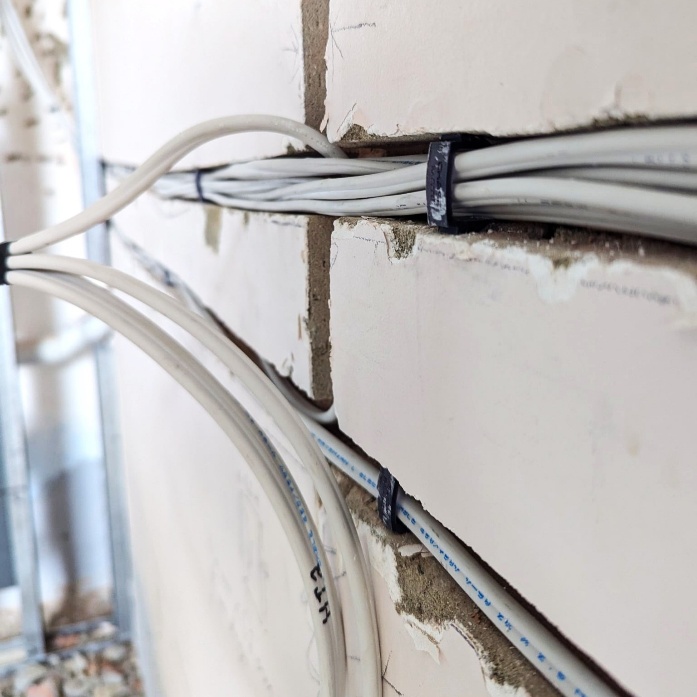 Cable bundles held firmly in chased channels by ChaseMate plugs