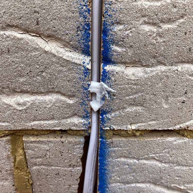 Improvised fix loosely holding a utility line in a chased wall channel