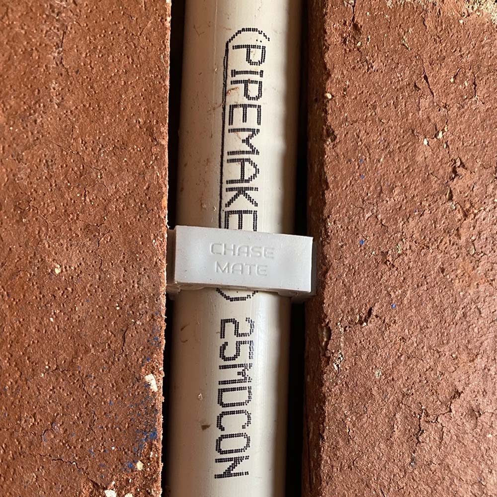 Large plug retaining pipe in a brick channel